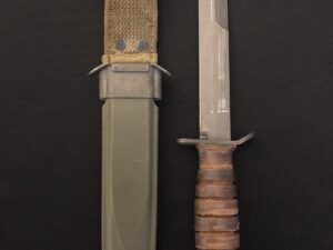 A military-style knife with a sheath on a black background.