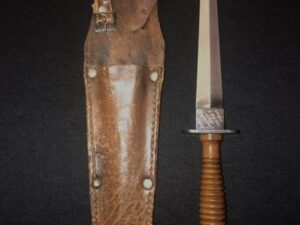 A vintage knife with a leather sheath.