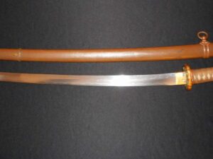 A traditional Japanese katana sword with its wooden scabbard.