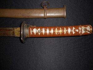 Close-up of a katana handle with traditional wrapping and guard.
