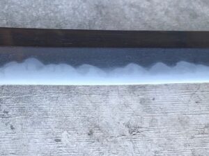 Close-up of a katana blade showing the hamon pattern.