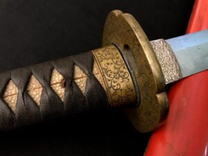 Close-up of a katana handle with detailed tsuba and wrapped tsuka.