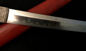 Close-up of a blade with engraved characters on the metal.