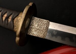 Close-up of an ornate sword hilt and blade with intricate designs.