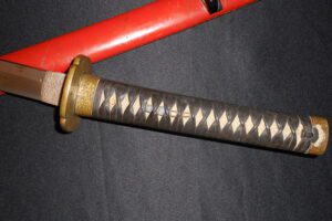 Close-up of a katana handle with traditional diamond-patterned wrapping.