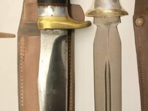 Two vintage hunting knives with leather sheaths side by side.