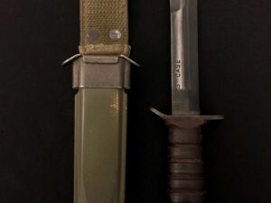 Knife with a green sheath and leather-wrapped handle on black background.