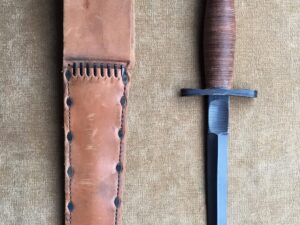 Antique dagger with wooden handle and leather sheath.