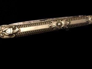 Ornate metallic decorative piece with intricate floral patterns.