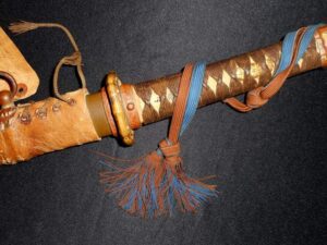 Close-up of a traditional Japanese sword handle with tassels.