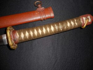 Close-up of a traditional Japanese katana handle and its scabbard.