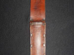 Brown leather sheath with a stitched design and snap closure.