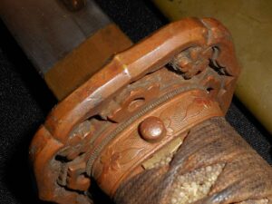 Close-up of a rusty mechanical joint with a bolt and worn metal parts.