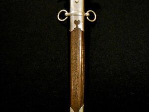 A wooden-handled dagger with a metal guard on a black background.