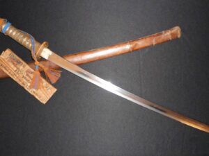 A traditional Japanese katana sword with a wooden sheath and handle.