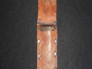 Vintage leather belt pouch with metal studs and button closure.