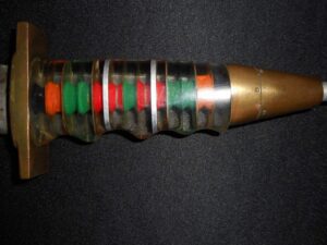 Close-up of a colorful, segmented object with a metallic gold tip.