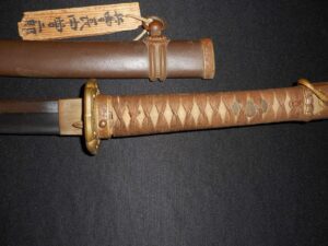 A traditional Japanese katana with intricate handle wrapping and a decorated scabbard.