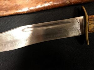 Close-up of a knife blade with visible markings on the metal.