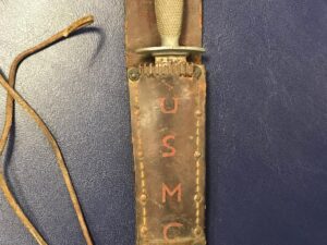 Close-up of a leather strap marked with 'U.S.M.C.'.