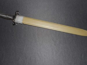 A fluorescent tube light lying on a gray surface.