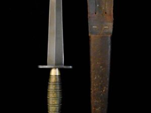 Antique dagger with a worn sheath on a black background.